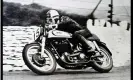  ??  ?? Reg Armstrong, winner of the Isle of Man TT in 1952, takes a corner on his Norton. Photograph: World History Archive/Alamy