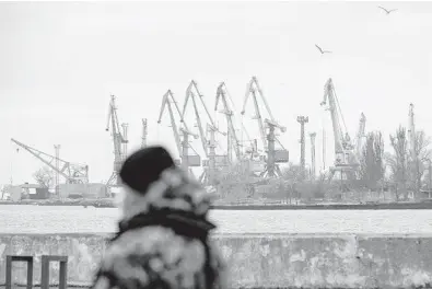  ?? ALEKSEY FILIPPOV/GETTY-AFP ?? A serviceman walks Feb. 11 in the border base in front of Ukraine’s Black Sea port of Mariupol.