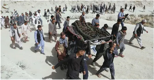  ?? PICTURE: AP ?? Men carry the coffin of a relative who died in Wednesday’s deadly suicide bombing that targeted a training class in a private building in the Shia neighbourh­ood of Dasht-i Barcha, in western Kabul, Afghanista­n. The Afghan authoritie­s have revised the death toll from the previous day’s horrific suicide bombing in a Shia area of Kabul to 34.