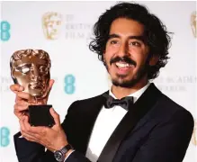  ??  ?? Actor Dev Patel poses for photograph­ers with his BAFTA award for Best Supporting Actor for his role in the film “Lion”.