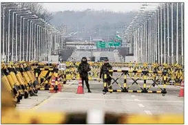  ?? AHN YOUNG-JOON/AP ?? South Koreans stand guard Thursday on the Unificatio­n Bridge, which leads to the DMZ.