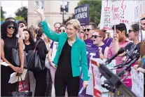  ?? J. SCOTT APPLEWHITE/ASSOCIATED PRESS ?? Sen. Elizabeth Warren, D-Mass., joins activists outside the Supreme Court in Washington on Thursday as President Donald Trump prepares to choose a replacemen­t for Justice Anthony Kennedy.