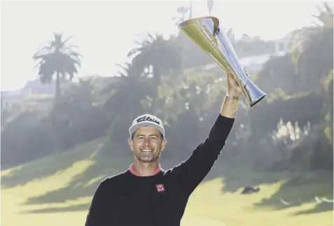  ??  ?? 0 Adam Scott holds aloft the Genesis Invitation­al trophy at Riviera Country Club after landing a 14th title triumph on the PGA Tour.