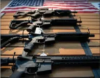  ?? JIM WATSON — AFP/GETTY IMAGES ?? Assault rifles hang on the wall for sale at Blue Ridge Arsenal in Chantilly, Virginia, in October 2017.