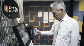  ??  ?? An employee uses a smartphone during a demonstrat­ion of buying bitcoin from an ATM in Tokyo. Mainstream consumers have yet to use cryptocurr­encies in great numbers, though they have been gaining buzz among investors.