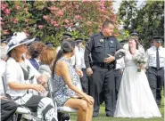  ?? Melissa Phillip / Houston Chronicle ?? Ray Hunt, Houston Police Officers’ Union president, escorts Cynthia Martin during her wedding at the Houston Police Officer Memorial.