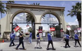  ?? Pictures in Los Angeles. (AP/Chris Pizzello) ?? Members of the The Writers Guild of America West picket Tuesday at an entrance to Paramount