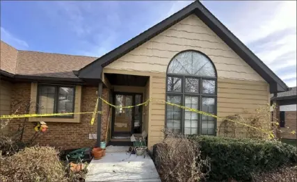  ?? Josh Funk/Associated Press photos ?? The front door of the rectory where Rev. Stephen Gutgsell was fatally stabbed on Dec. 10 in tiny Fort Calhoun, Neb., remained wrapped in crime scene tape on Dec. 14. Gutgsell’s killing was the second one in the small town in the last four months.