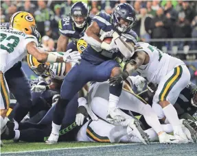  ??  ?? Running back Chris Carson, scoring a TD Sunday, leads Seattle’s league-best rushing unit (154.3 ypg) with 580 yards.