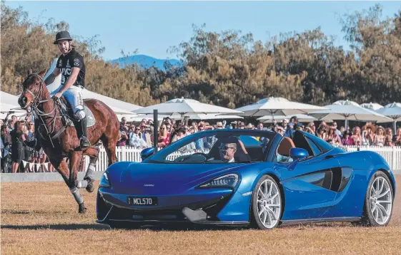  ?? Picture: JERAD WILLIAMS ?? Supercars driver James Courtney guns the McLaren past polo player Jordan Lamaison at Doug Jennings Park on Saturday.