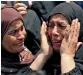  ??  ?? Relatives react during the funeral of officer Khaled Al Maghrabi in Toukh, Al Qalyubia Governorat­e, on Saturday. —