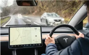  ?? ?? LEFT Tesla drivers are meant to hold on to the steering wheel, but do they really?