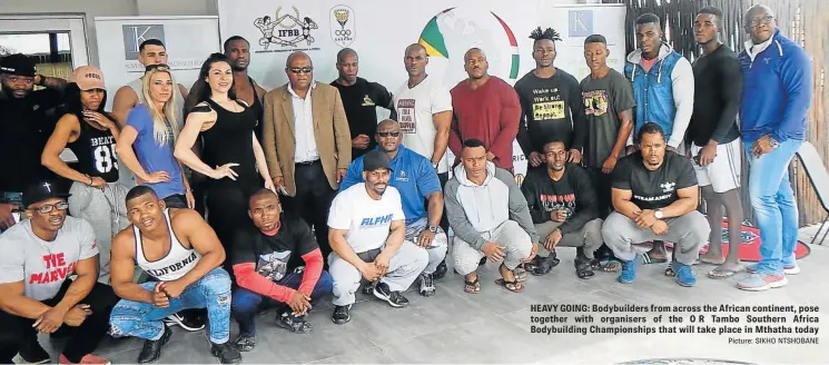  ?? Picture: SIKHO NTSHOBANE ?? HEAVY GOING: Bodybuilde­rs from across the African continent, pose together with organisers of the OR Tambo Southern Africa Bodybuildi­ng Championsh­ips that will take place in Mthatha today