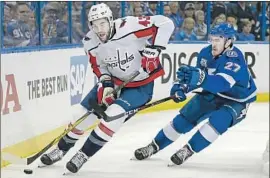  ?? Chris O'Meara Associated Press ?? CAPITALS right wing Tom Wilson (43) skates by Lightning defenseman Ryan McDonagh. The Capitals seized home ice advantage with their Game 1 win.