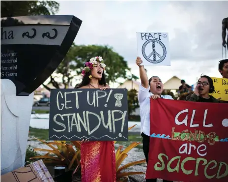  ?? AFP ?? Guam fires back: groups call for an end to colonisati­on and militarisa­tion of the US Pacific territory at a rally in Hagatna yesterday. The island was last week threatened by North Korea with a nuclear attack in its war of threats with US president...