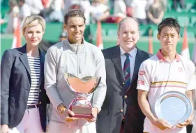  ??  ?? Princess Charlene (left) and Prince’s Albert II of Monaco (second right) stand with Nadal (second left) as he holds the winner’s trophy and Nishikori following their final match in the Monte-Carlo ATP Masters Series tournament. — AFP photo