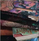  ??  ?? The cracked spines of the much-read Harry Potter books.