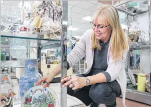  ?? MILLICENT MCKAY/ JOURNAL PIONEER ?? Anna MacDonald, manager of the Salvation Army Thrift Store, tidies up a display of china teacups and plates. To celebrate the year of changes, MacDonald has planned a customer appreciati­on week from May 14 to 19.