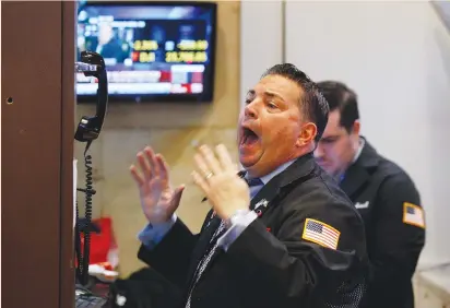  ?? (Brendan Mcdermid/Reuters) ?? A TRADER reacts on the floor of the New York Stock Exchange yesterday. The sharp declines in recent days marked a pullback that was long awaited by investors after the market minted record high after record high in a relatively calm ascent.