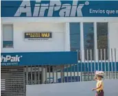  ?? INTI OCON/AP ?? A candy vendor walks past a Western Union branch Saturday in Managua, Nicaragua. Remittance­s to Nicaraguan­s sent home in 2022 surged 50%.