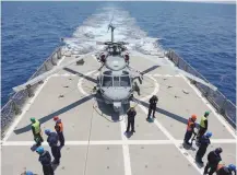  ??  ?? A Hellenic Navy frigate is seen with a helicopter on its deck during a naval exercise earlier this year.