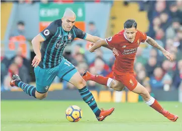  ??  ?? File photo shows Liverpool’s Philippe Coutinho in action with Southampto­n’s Oriol Romeu. — Reuters photo