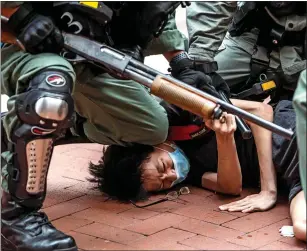  ??  ?? BRUTAL REGIME: Xi Jinping leads China’s ‘gangster government’. Left: Armed police suppress pro-democracy campaigner­s in Hong Kong last week