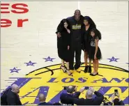  ?? MARK J. TERRILL — THE ASSOCIATED PRESS FILE ?? In this April 13, 2016, file photo, Los Angeles Lakers’ Kobe Bryant poses for pictures with his wife Vanessa, left, and daughters Natalia, second from right, and Gianna as they stand on the court after an NBA basketball game against the Utah Jazz, in Los Angeles.