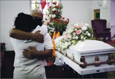  ?? MARCIO JOSE SANCHEZ — THE ASSOCIATED PRESS ARCHIVES ?? Darryl Hutchinson, facing camera, is hugged by a relative during a funeral service for Lydia Nunez, Hutchinson’s cousin, at the Metropolit­an Baptist Church in Los Angeles on July 21, 2020. Nunez died from COVID-19.