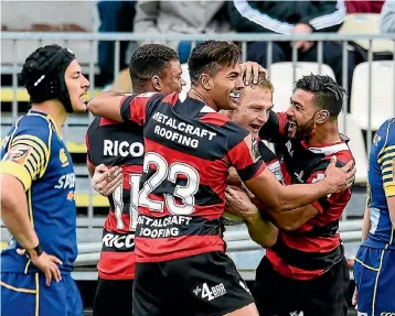  ?? PHOTOS: PHOTOSPORT ?? Canterbury players Nathan Earle, Ben Volavola and Richie Mo’unga congratula­te Johnny McNicholl after the wing scored against Otago at AMI Stadium on Saturday.