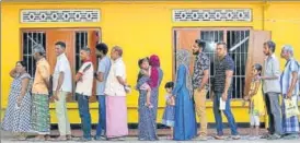  ?? REUTERS ?? ■
People stand in a line to cast their vote during the presidenti­al election in Colombo.