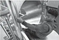  ?? Ken Ruinard/The Independen­t-Mail via AP ?? ■ In this 2017 photo, Clemson running back Darien Rencher goes down a slide inside the Clemson Football Facility at Clemson University in Clemson, S.C. When it comes to facilities in the ACC, Clemson has set the standard.