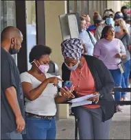  ?? (Arkansas Democrat-Gazette/Staci Vandagriff) ?? People wait in line to file unemployme­nt claims Thursday at the Arkansas Workforce Center in Little Rock.