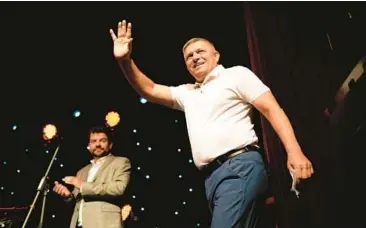  ?? PETR DAVID JOSEK/AP ?? Former Slovakia prime minister and head of leftist Smer, Social Democracy party, Robert Fico, waves to his supporters during an election rally Sept. 6 in Michalovce, Slovakia. He has campaigned on a clear pro-Russian message.