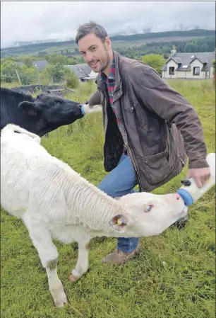  ?? Photograph: Iain Ferguson, The Write Image. F28 ross macgregor 01 IF ?? Ross MacGregor feeds Angus the young bull and calf Charlie.