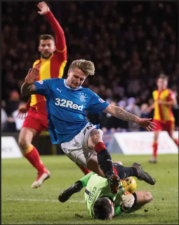  ??  ?? Tomas Cerny dives at the feet of Jason Cummings to deny the on-loan Rangers forward at Firhill