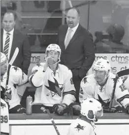  ?? MEL EVANS, THE ASSOCIATED PRESS ?? San Jose Sharks head coach Peter DeBoer, standing right, instructs his players during the first period against New Jersey Sunday.