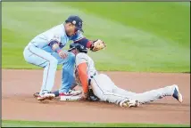  ??  ?? Detroit Tigers’ Victor Reyes beats the tag attempt by Minnesota Twins shortstop Jorge Polanco to steal second base during the first inning of a
baseball game on Sept 23, in Minneapoli­s. (AP)