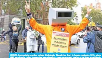  ??  ?? LONDON: Demonstrat­ors protest outside Westminste­r Magistrate­s Court in London yesterday, 2019, where WikiLeaks founder Julian Assange has been attending a case management hearing as he fights extraditio­n to the United States. — AFP