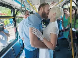  ?? ARLEN REDEKOP/ PNG ?? Jarred Greff and Nina Schmidt get married on a Coast Mountain transit bus in Vancouver on Tuesday. They first met on the No. 3 bus route on Main Street last April. ‘ It was our dream wedding,’ says Schmidt.