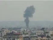  ?? HATEM MOUSSA/AP ?? Smoke rises from a building hit by Israeli airstrikes on Friday in Gaza City. Palestinia­n officials said a senior militant was among at least 10 people killed.