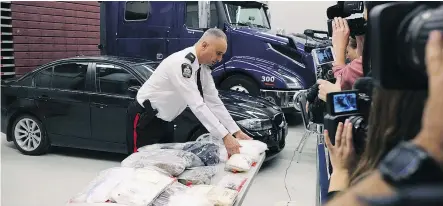  ?? —KEVINKING ?? Insp. Max Waddell of the Winnipeg Police Service’s organized crime unit displays methamphet­amine during a media event in Winnipeg on Nov. 1.