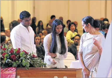  ?? Pictures: EUGENE COETZEE ?? FINAL FAREWELL: Dayaan, Neritika and Maya Padayachey say a final goodbye at the open casket of biker Dayalan Padayachey as about 1 500 people gathered at the Boardwalk Convention Centre for his memorial service