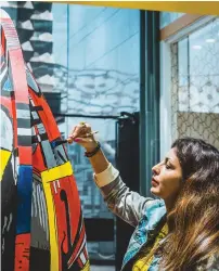  ??  ?? Purva Kaushal turning a dhow into a large colourful piece of red, yellow and blue abstract during the exhibition at the City Walk.