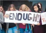  ?? MARLA BROSE/JOURNAL ?? From left, Aly Loidolt, Lorelei Breitfeld and Malak Youssef join about 350 students from La Cueva High for a moment of silence Feb. 21 in honor of the victims of school shootings.