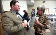  ?? NWA Democrat-Gazette/J.T. WAMPLER ?? Lisa Cordes (right), director of artist services for Mid-America Arts Alliance, visits Monday with Patrick Ralston, director of the Arkansas Arts Council, at the Bentonvill­e Public Library before an announceme­nt about the Artist 360 program. The...