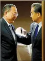  ?? AP/BULLIT MARQUEZ ?? North Korean Foreign Minister Ri Yong Ho (left) and Chinese Foreign Minister Wang Yi end their meeting Sunday in Manila, Philippine­s.