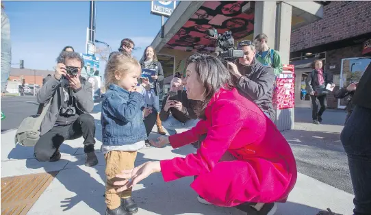  ?? CHRISTINNE MUSCHI ?? Projet Montréal leader Valérie Plante meets three-year-old Ayma as Plante campaigns in Montreal on Saturday. Municipal elections will be held across Quebec on Nov. 5.