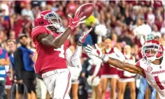  ?? Vasha Hunt/Associated Press ?? ■ Alabama wide receiver Jerry Jeudy (4) catches a touchdown pass against Arkansas on Saturday in Tuscaloosa, Ala.