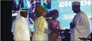  ??  ?? Mr. Mohammed Fall, presenting the award to Mrs. Gimiya Dogara, who stood in for wife of the President, Mrs. Aisha Buhari while Mr. Oghomienor and DG, NCWD, Mrs. Mary Ekpere - Eta